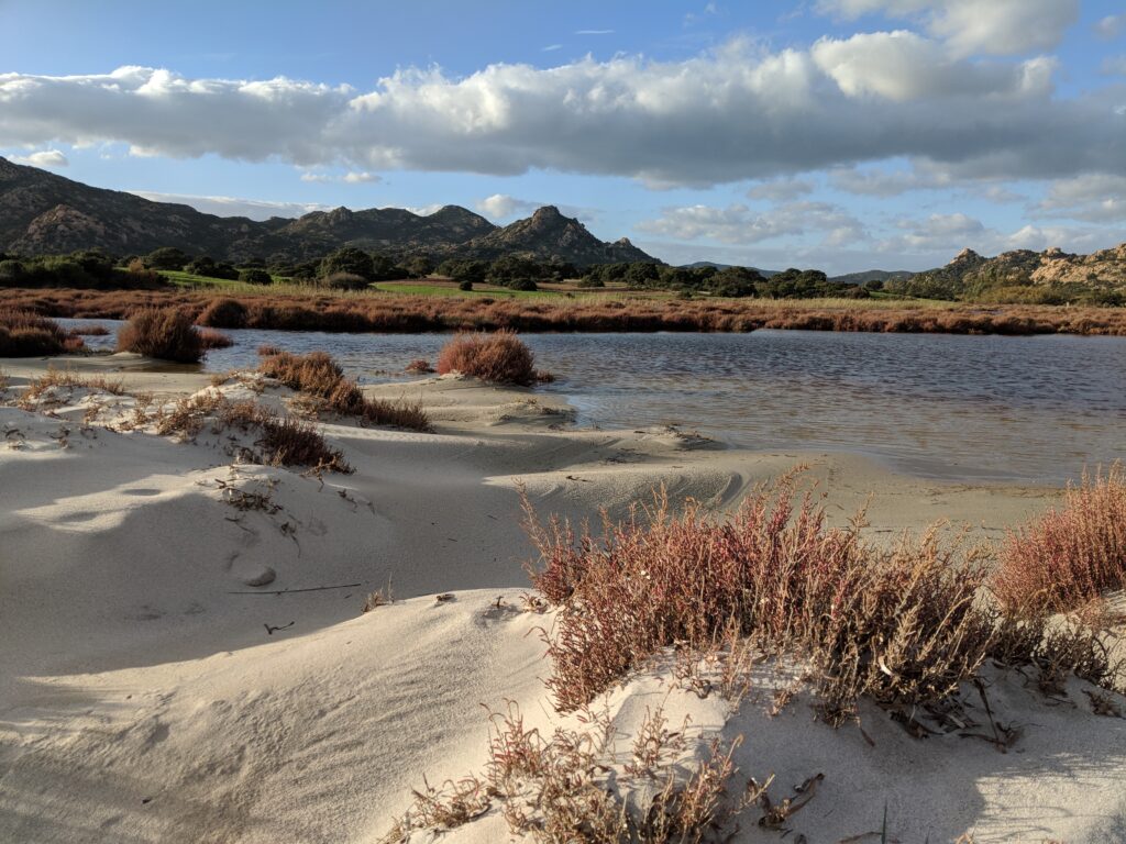 Sardegna mountains with green pastures and coast side swamp lake